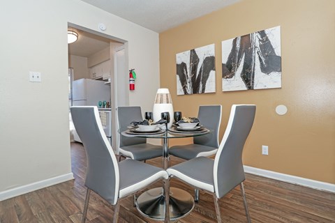 A dining room with a table set for four at The Drake in Bossier City, LA